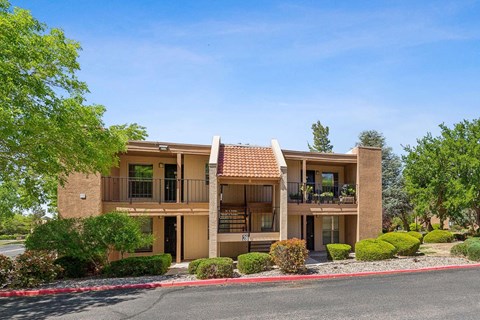 a building with a porch and a street in front of it at Acacia Gardens, Albuquerque, NM, 87111